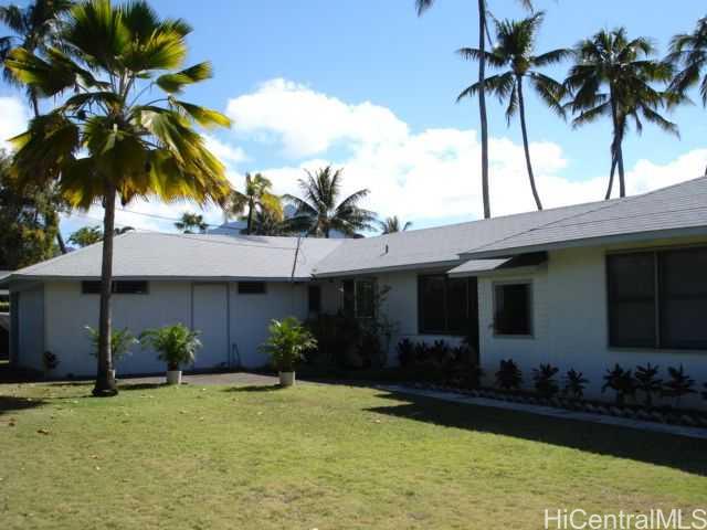 a palm tree in front of a house