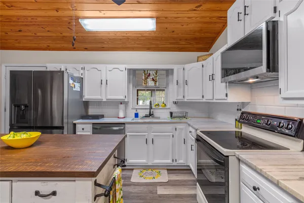a kitchen with a sink a stove and cabinets
