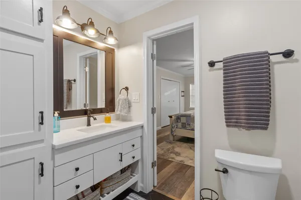 a spacious bathroom with a double vanity sink toilet mirror and bathtub