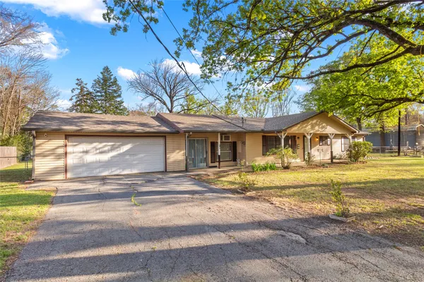 a yellow house with trees in front of it