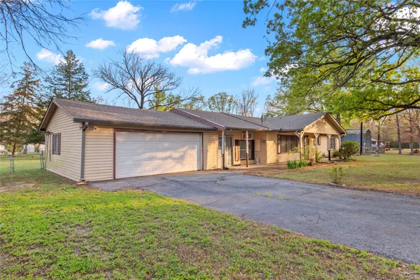 a view of a house with a yard and garage