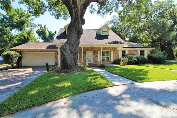 a front view of house with yard and green space
