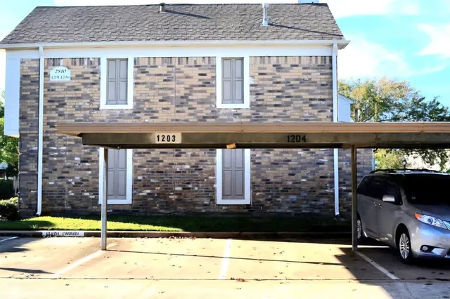 a view of a brick house with many windows