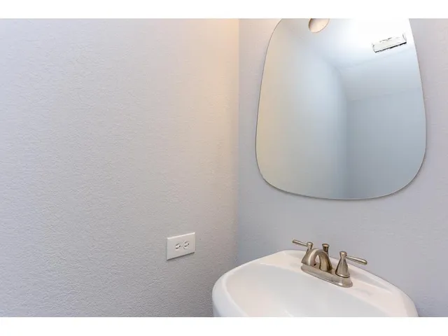 a bathroom with a sink and mirror