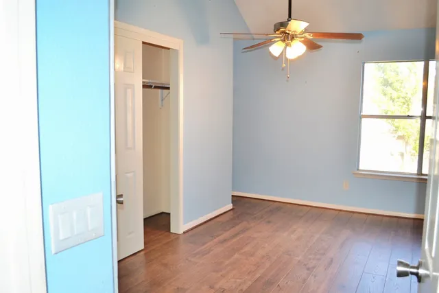 wooden floor in an empty room with a window