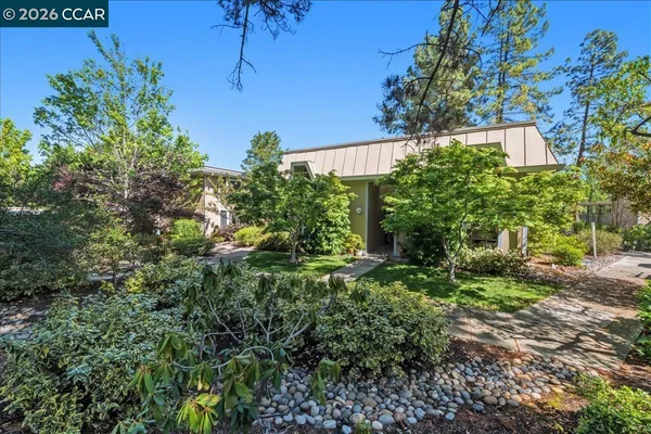a backyard of a house with a yard and outdoor seating