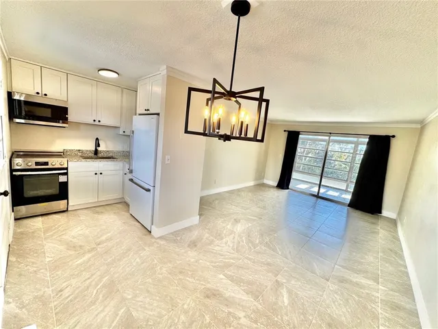 a view of a kitchen with a sink and dishwasher