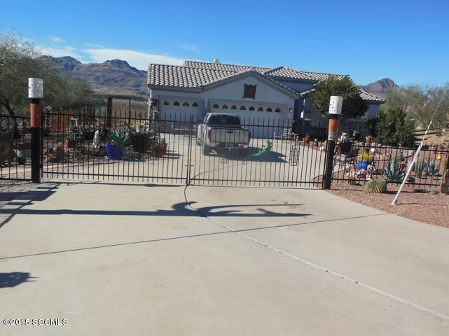 22 Virrey Court Rio Rico, AZ 85648 - Photo 1 of 14 a front view of a house with a garden and plants