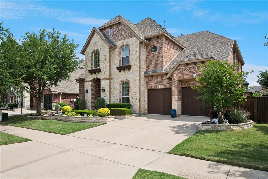 8268 Kara Creek Road Frisco, TX 75036 - Photo 2 of 31 Stone and brick facade residence featuring arched windows and a multi-gabled roofline