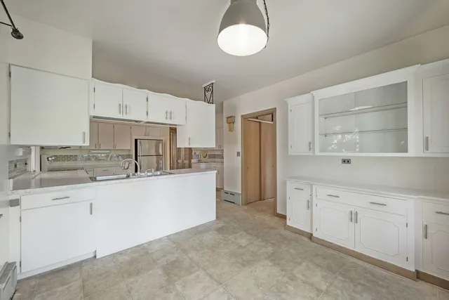 a kitchen with cabinets a sink and appliances