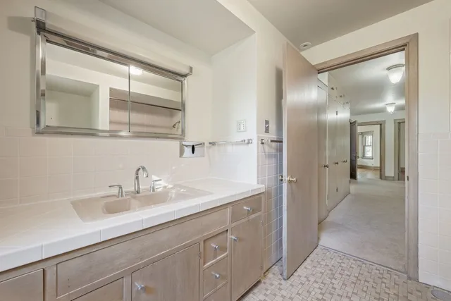 a bathroom with a sink a vanity and a mirror