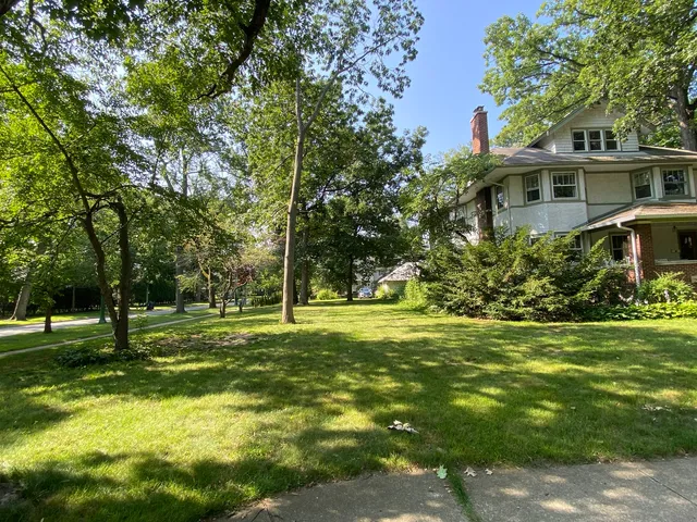 a view of a backyard with chairs and a patio