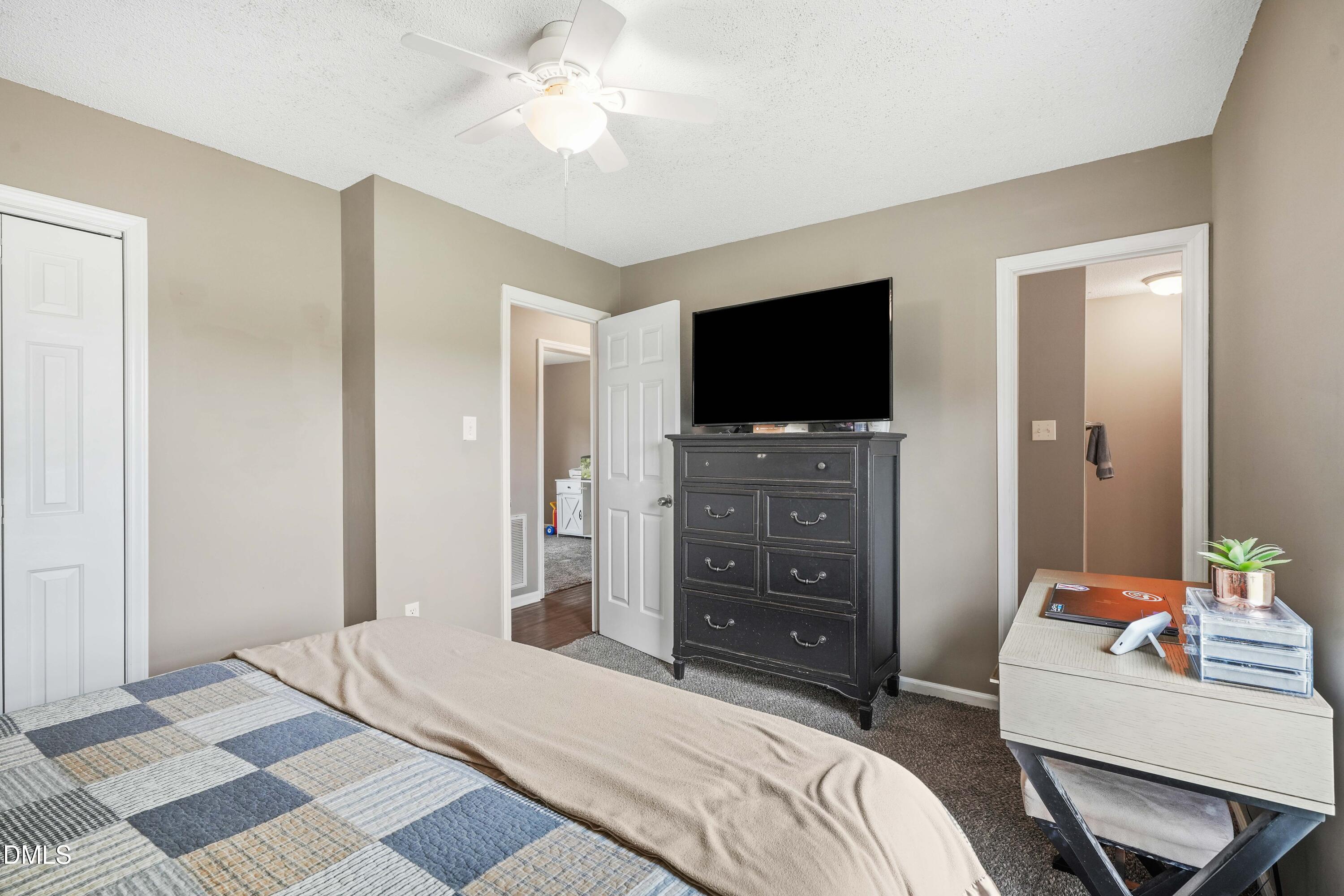101 Stephenson Road Benson, NC 27504 - Photo 14 of 29 a bedroom with a bed and a flat screen tv