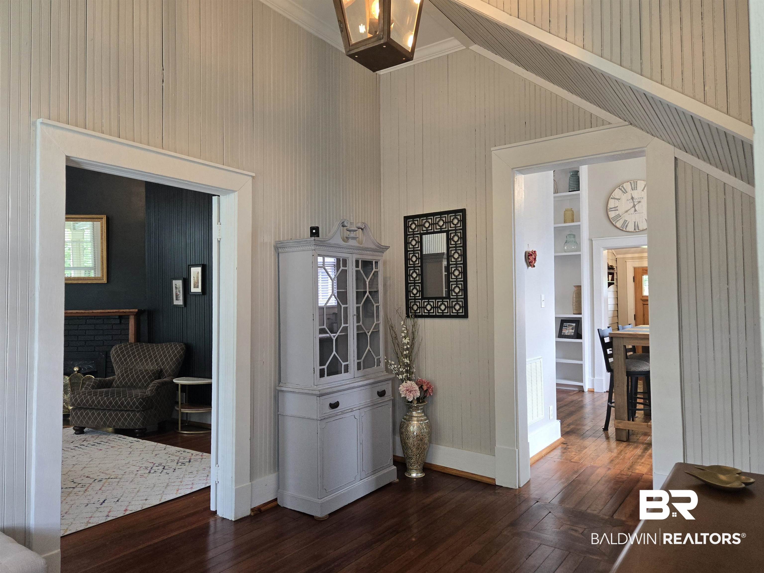 54 South Catherine Street Mobile, AL 36604 - Photo 10 of 55 Corridor featuring dark wood-style flooring, baseboards, vaulted ceiling, wooden walls, and ornamental molding
