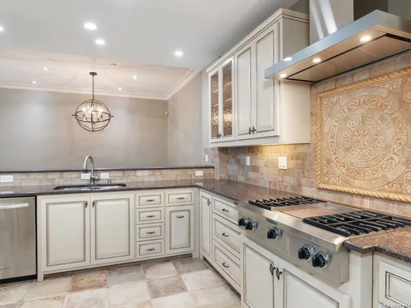 a kitchen with cabinets appliances and a counter top