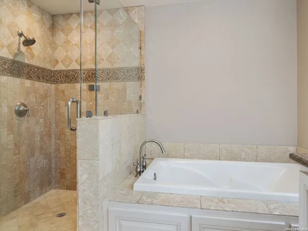 a bathroom with a bathtub and shower