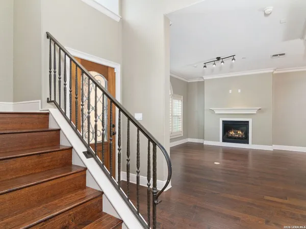 a view of an entryway with wooden floor and a fireplace