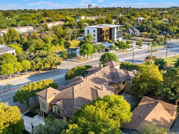 an aerial view of residential houses with outdoor space