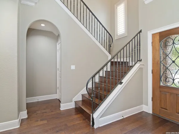 a view of staircase with wooden floor and a rug