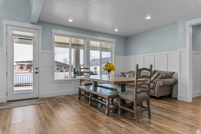 1426 South 1450th Street West Mapleton, UT 84664 - Photo 10 of 50 Spacious open-concept room featuring wood-finish flooring, recessed lighting, and board-and-batten wall detailing
