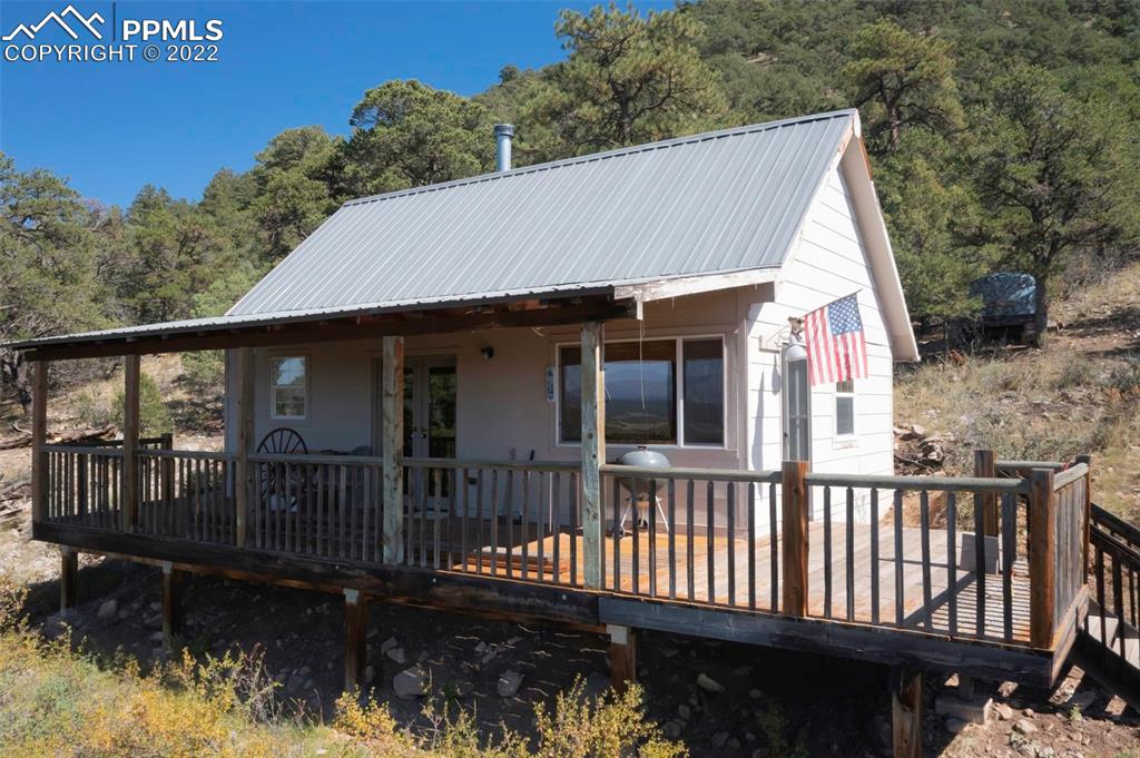 2126 E Path Cotopaxi, CO 81223 - Photo 1 of 34 a view of a house with wooden deck and furniture