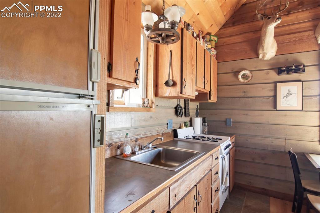 2126 E Path Cotopaxi, CO 81223 - Photo 8 of 34 a kitchen with a sink and a refrigerator