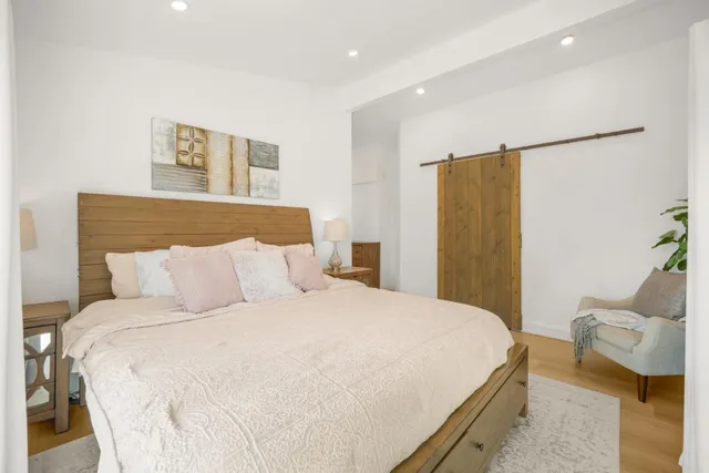 a bedroom with a bed and a couch