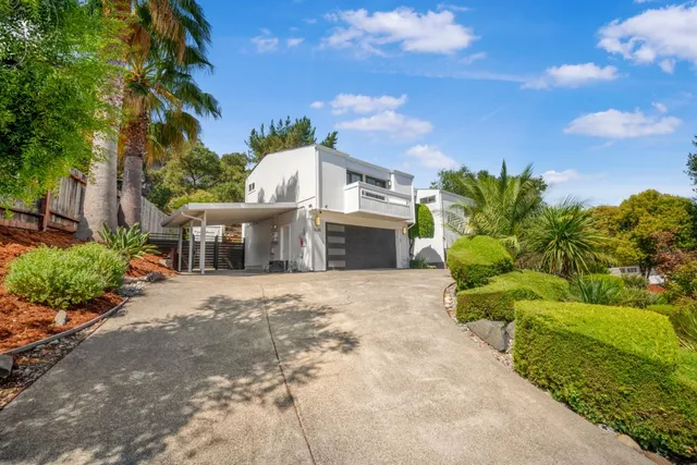 a front view of a house with a yard and outdoor seating