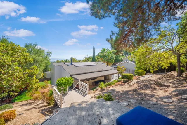 a view of a house with a tree in the background