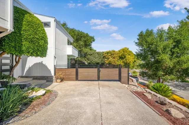 a view of a lush green field with mountains in the background