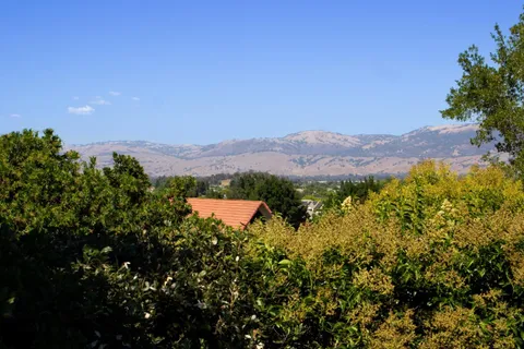 an aerial view of a house with yard swimming pool and outdoor seating