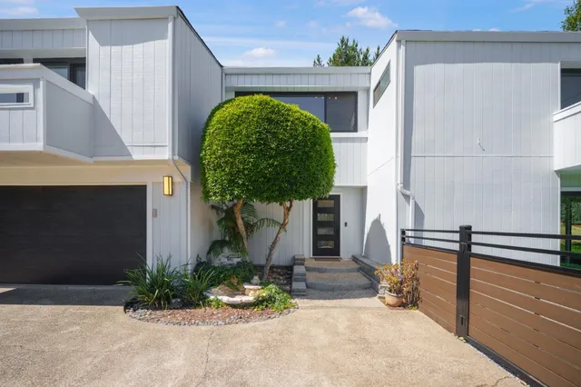 a front view of a house with garden