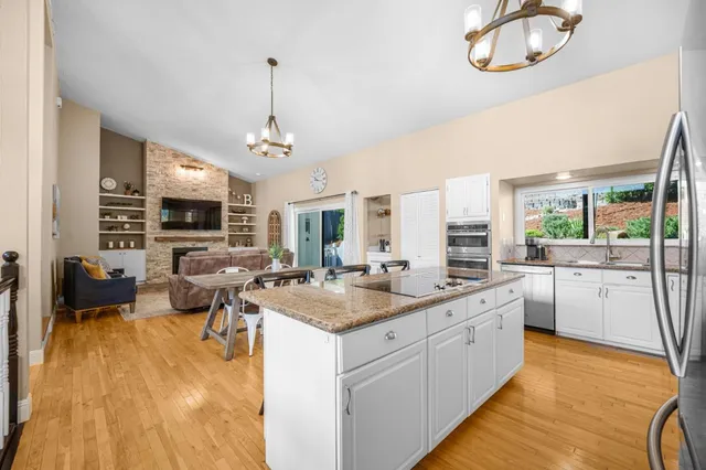 a large white kitchen with a large window