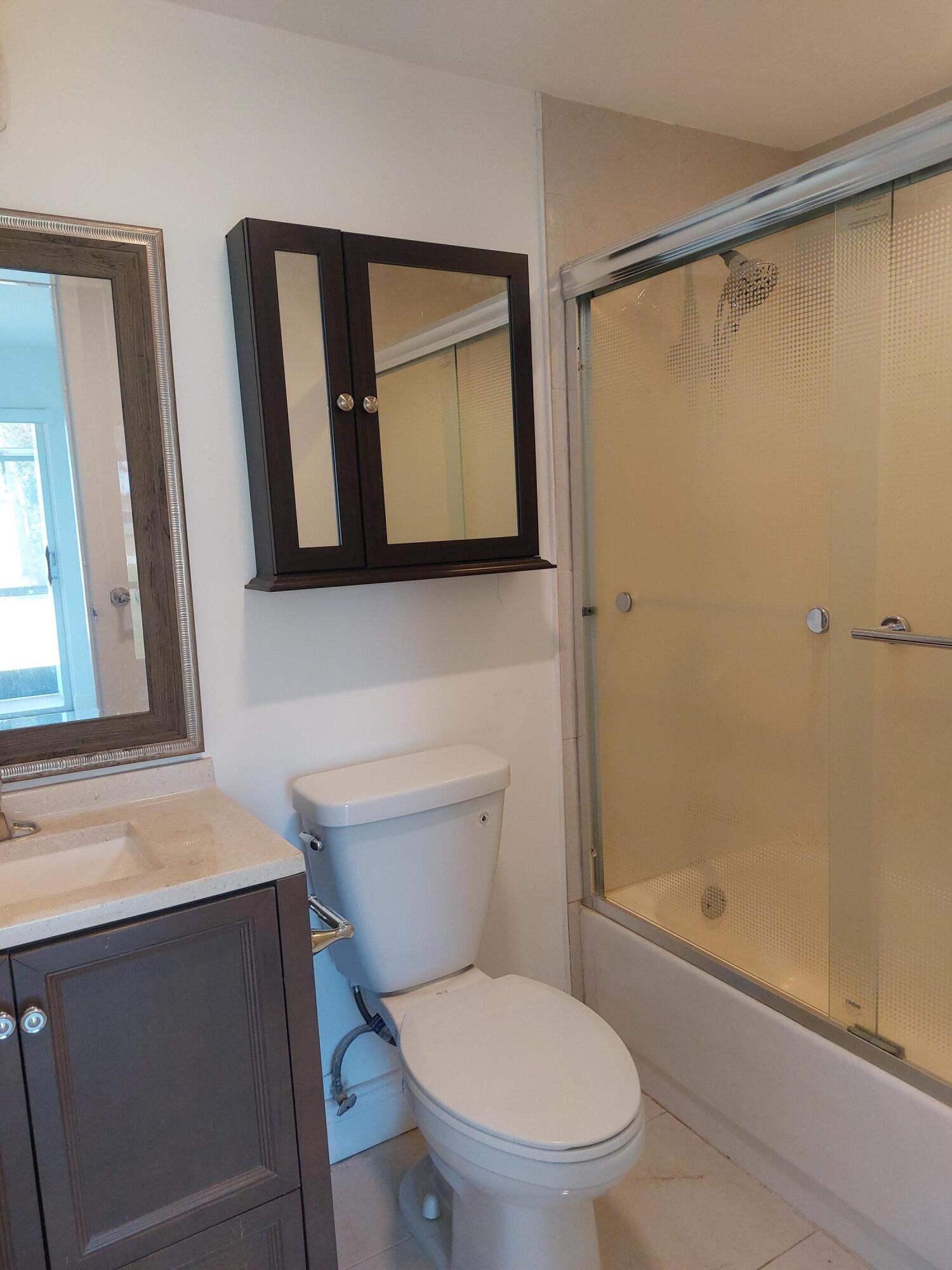 362 Tuscany G Delray Beach, FL 33446 - Photo 10 of 10 a bathroom with a toilet sink and shower