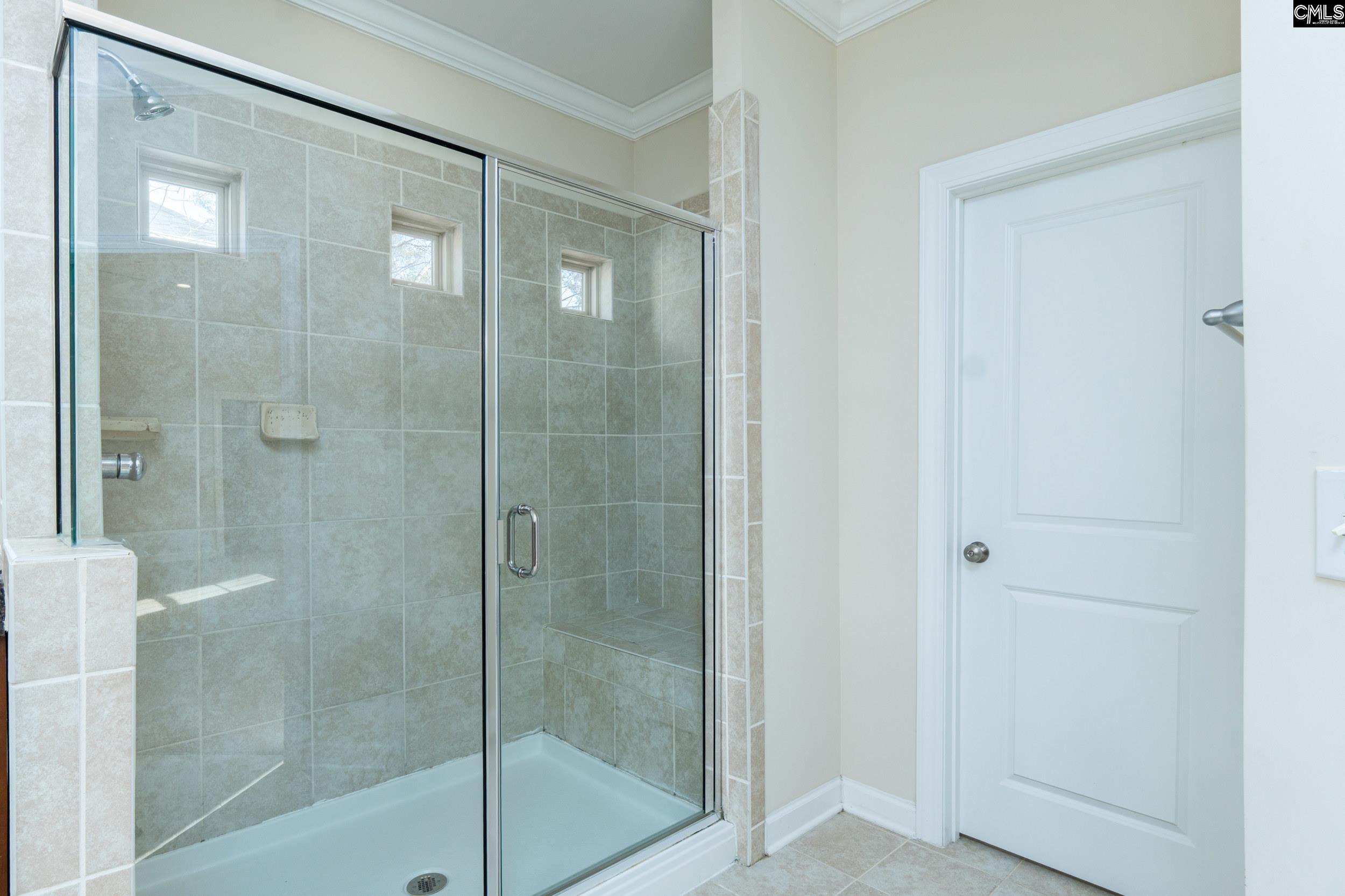 40 Wading Bird Loop Blythewood, SC 29016 - Photo 18 of 26 a bathroom with a glass shower door