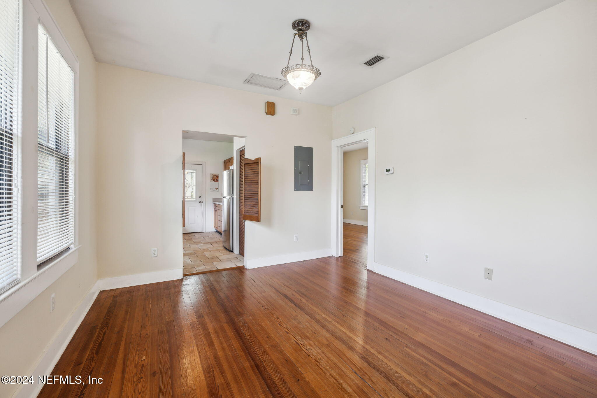 2887 Forbes Street Jacksonville, FL 32205 - Photo 11 of 35 a view of an empty room with wooden floor and a window