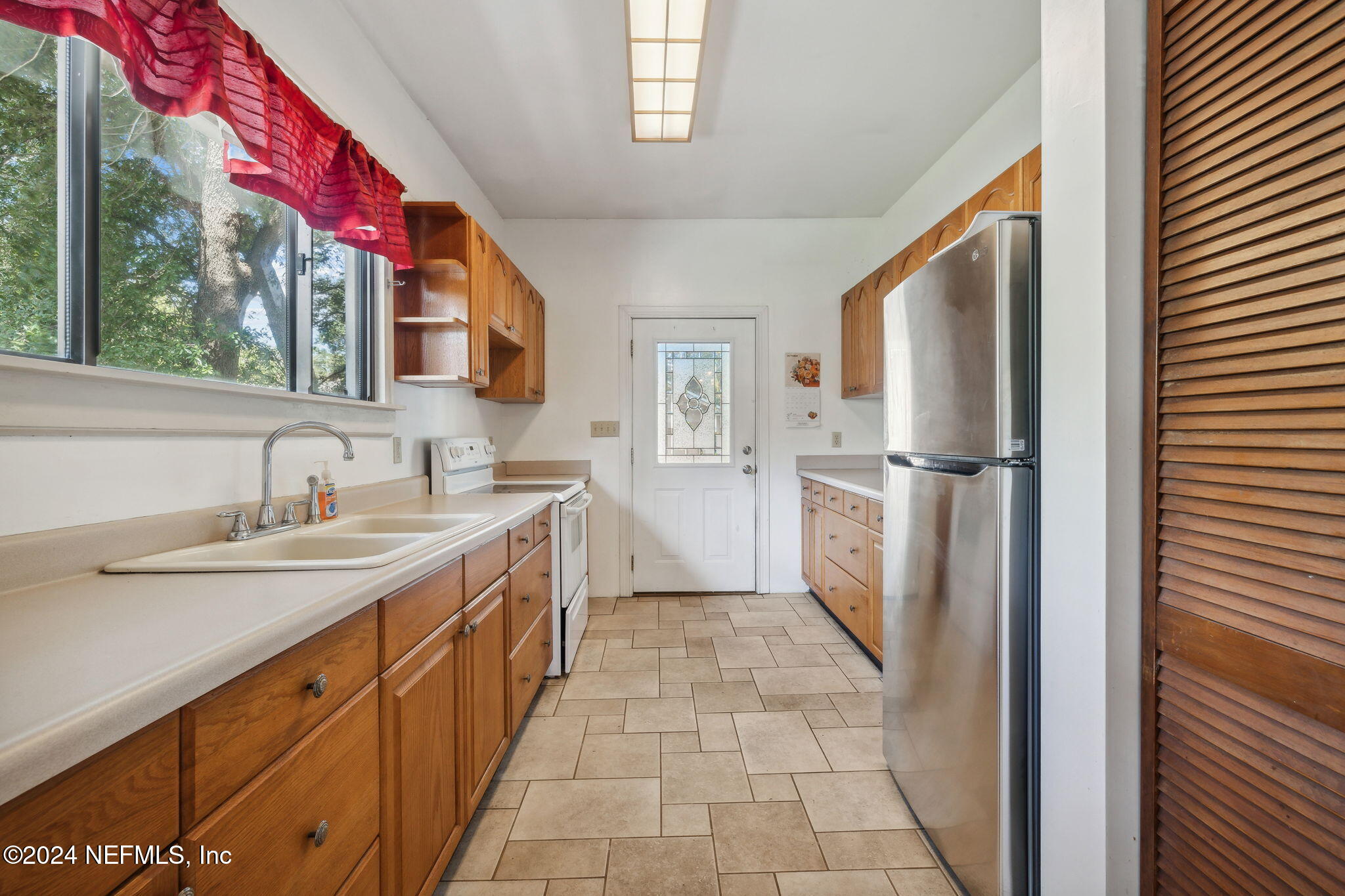 2887 Forbes Street Jacksonville, FL 32205 - Photo 12 of 35 a kitchen with a sink stove and refrigerator