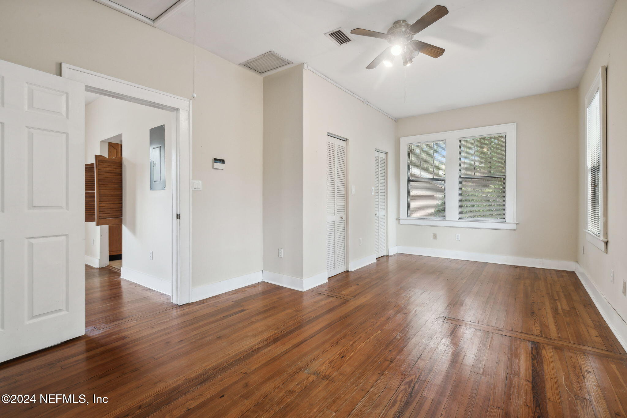 2887 Forbes Street Jacksonville, FL 32205 - Photo 17 of 35 a view of an empty room with wooden floor and a window