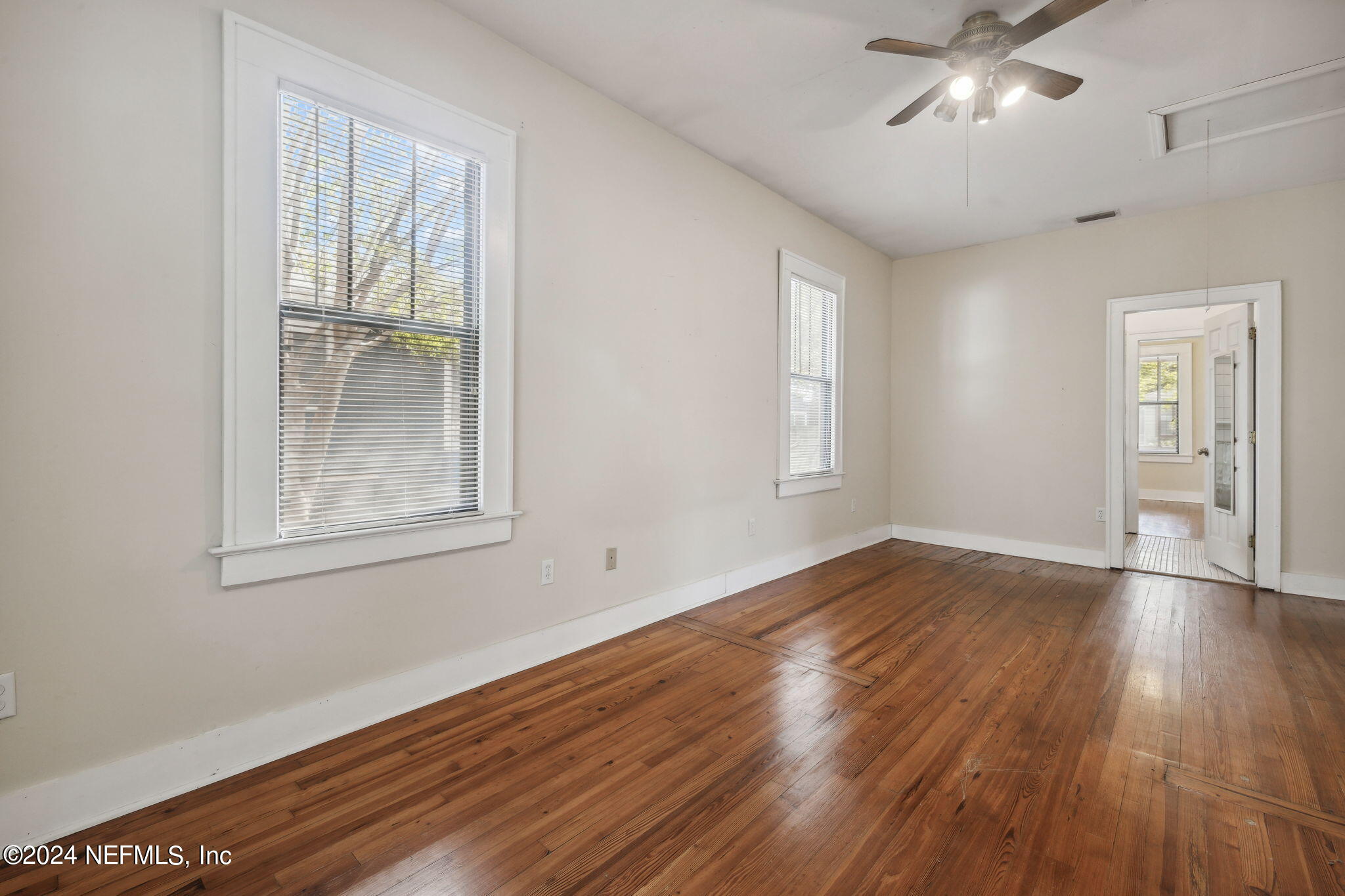 2887 Forbes Street Jacksonville, FL 32205 - Photo 18 of 35 an empty room with wooden floor and windows