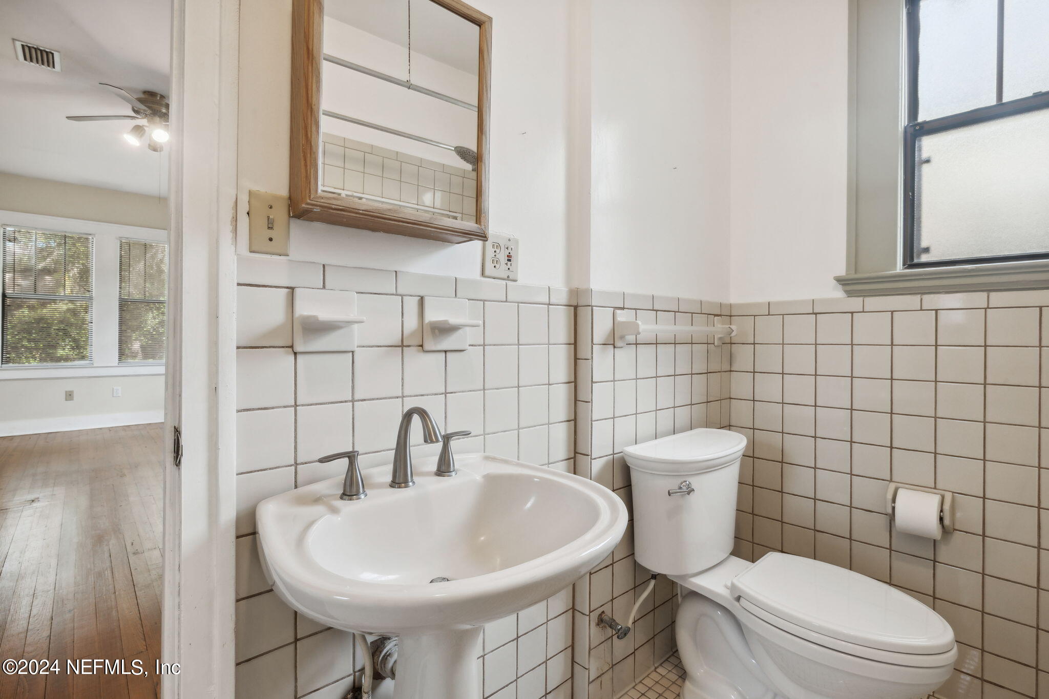 2887 Forbes Street Jacksonville, FL 32205 - Photo 19 of 35 a bathroom with a sink toilet and mirror