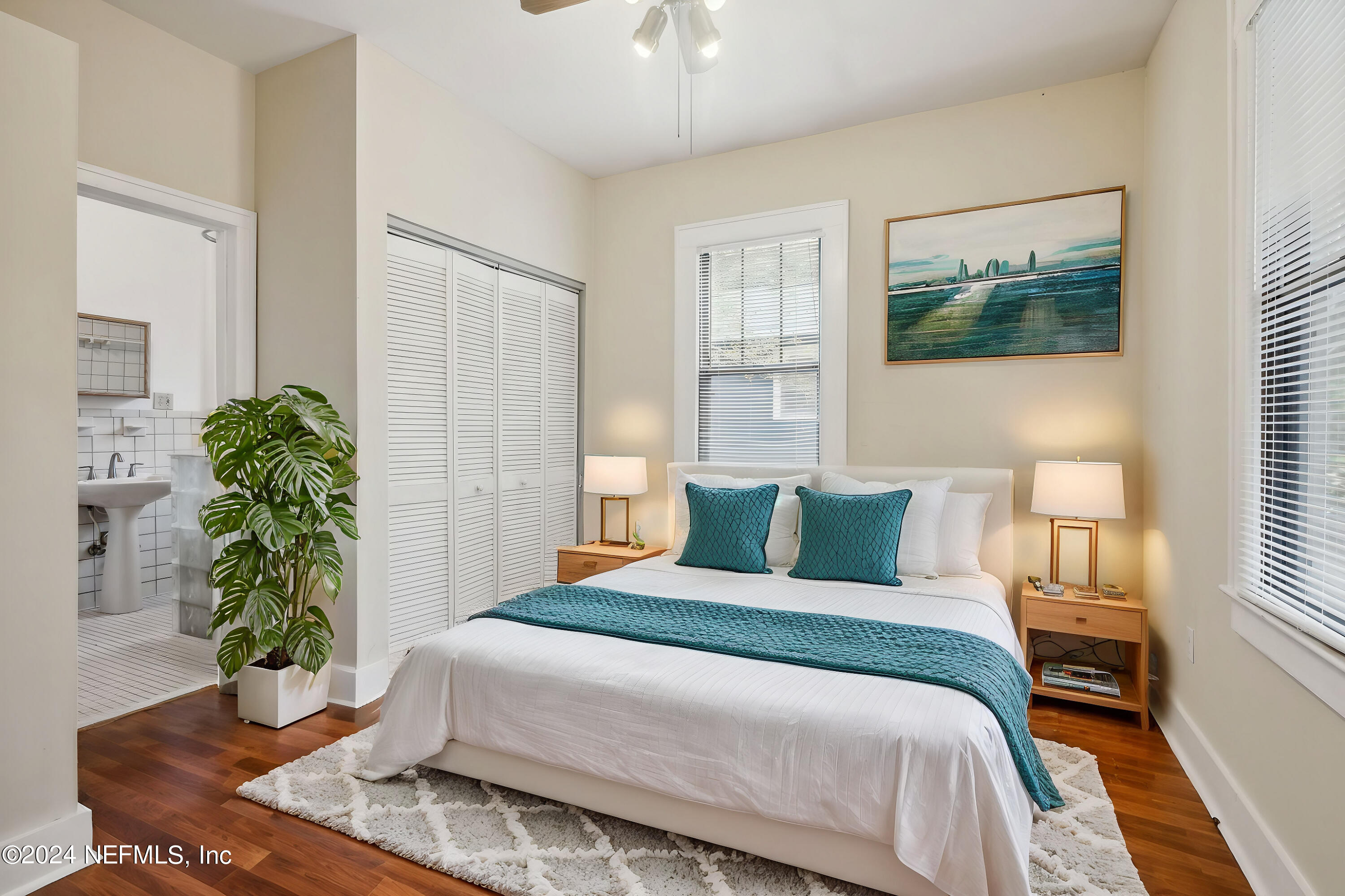 2887 Forbes Street Jacksonville, FL 32205 - Photo 21 of 35 a bedroom with a large bed and a potted plant