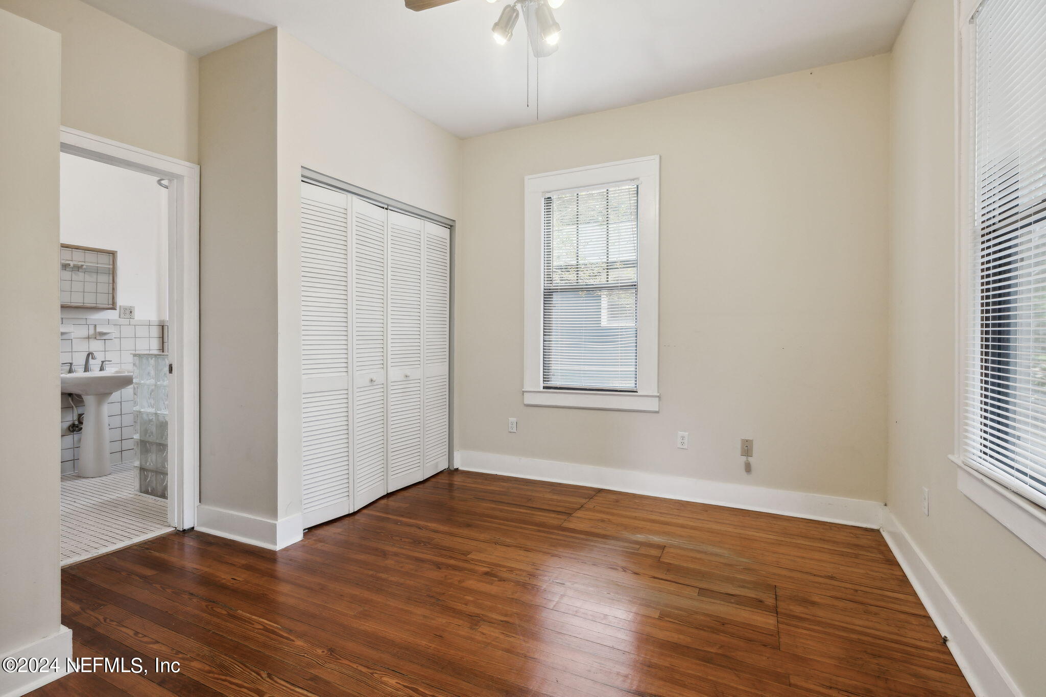 2887 Forbes Street Jacksonville, FL 32205 - Photo 22 of 35 wooden floor in an empty room with a window