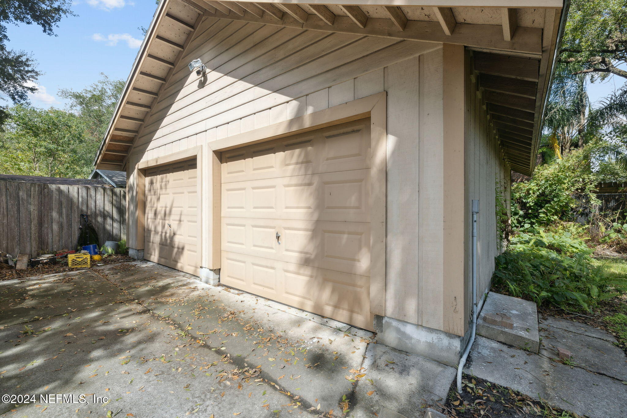 2887 Forbes Street Jacksonville, FL 32205 - Photo 26 of 35 a backyard of a house with table and chairs and wooden fence