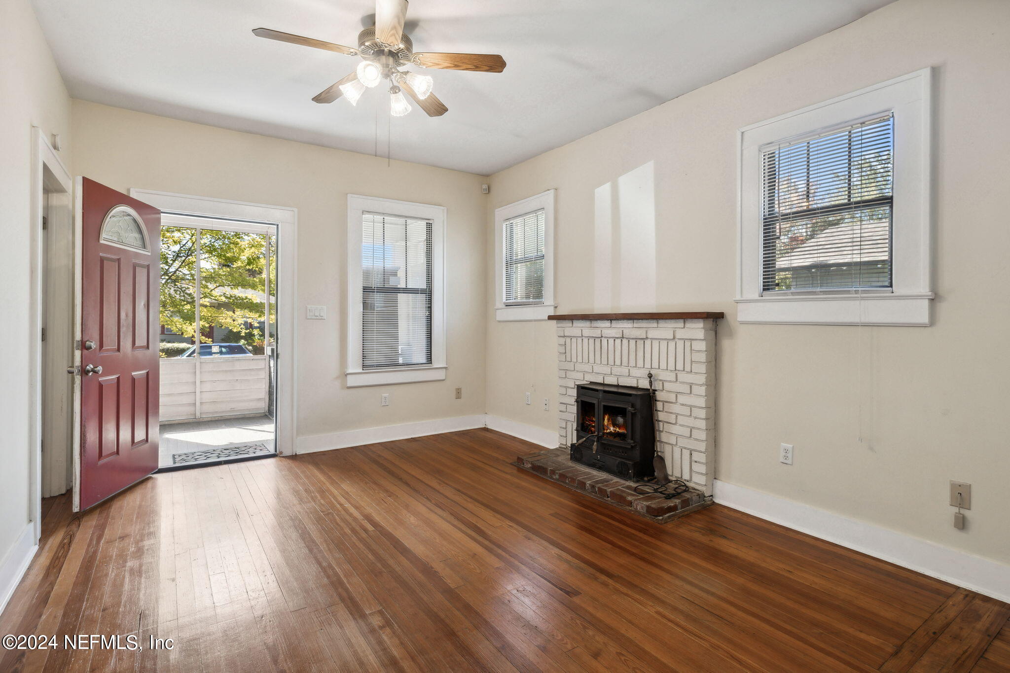 2887 Forbes Street Jacksonville, FL 32205 - Photo 6 of 35 wooden floor fireplace and windows in an empty room