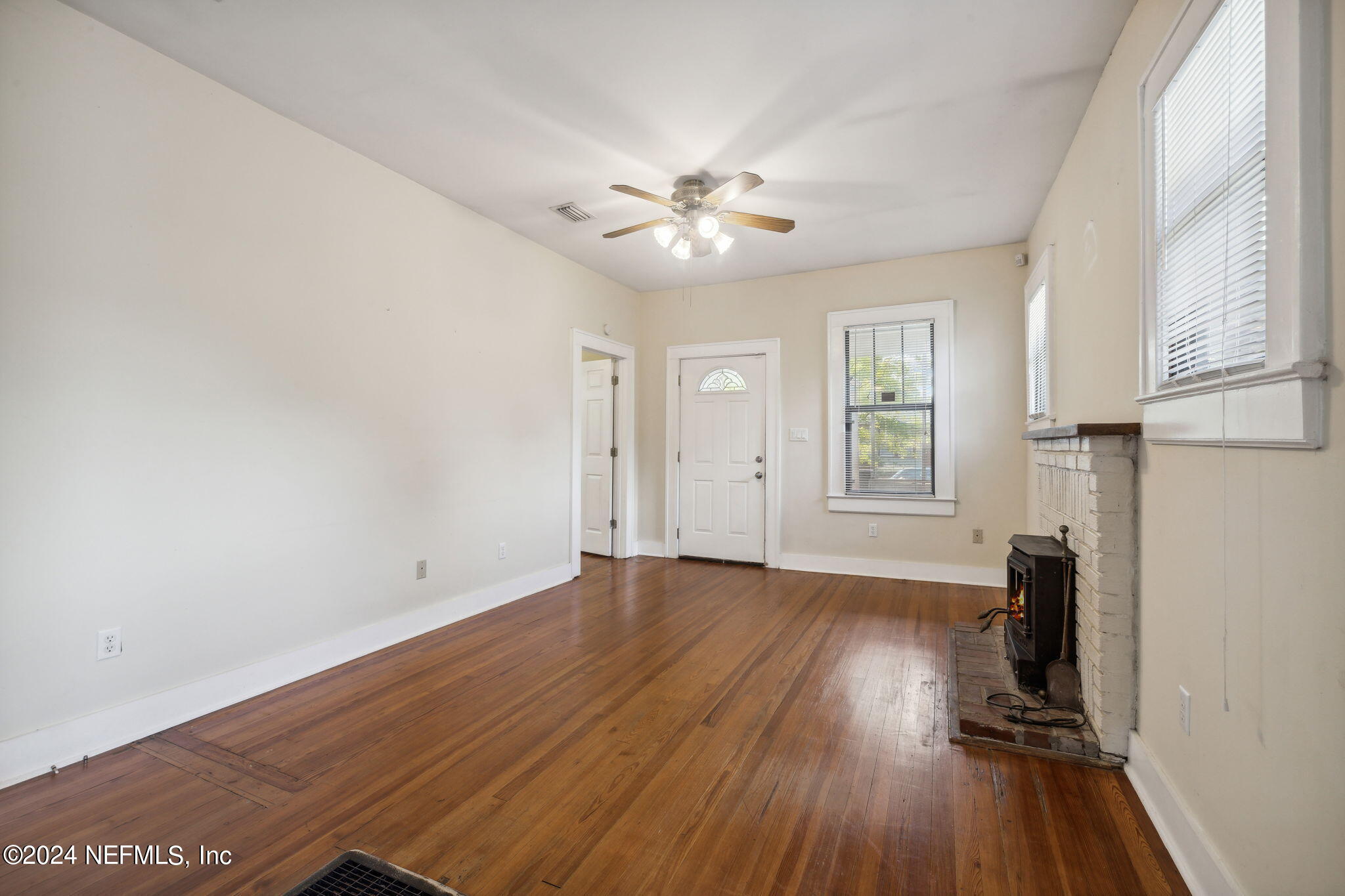 2887 Forbes Street Jacksonville, FL 32205 - Photo 7 of 35 wooden floor in an empty room with a window