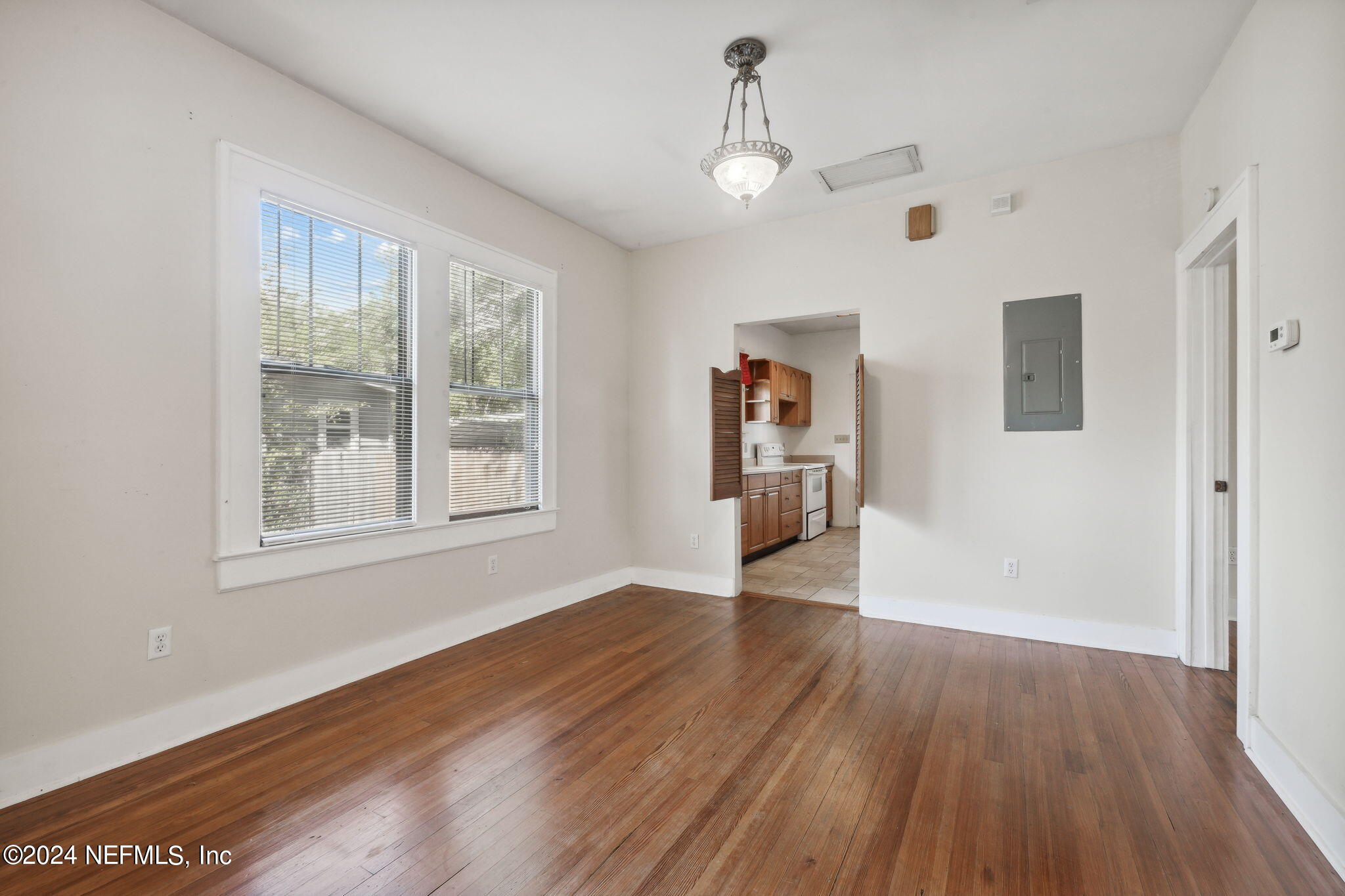 2887 Forbes Street Jacksonville, FL 32205 - Photo 10 of 35 a view of an empty room with window and wooden floor