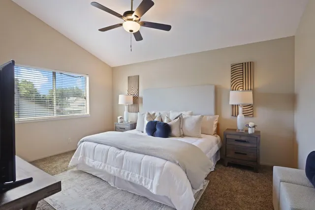 a bedroom with a bed and a painting on the wall