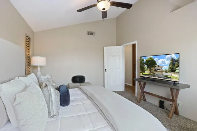 a bedroom with a bed and a window