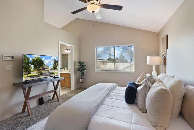 a spacious bathroom with a double vanity sink a mirror and a bathtub