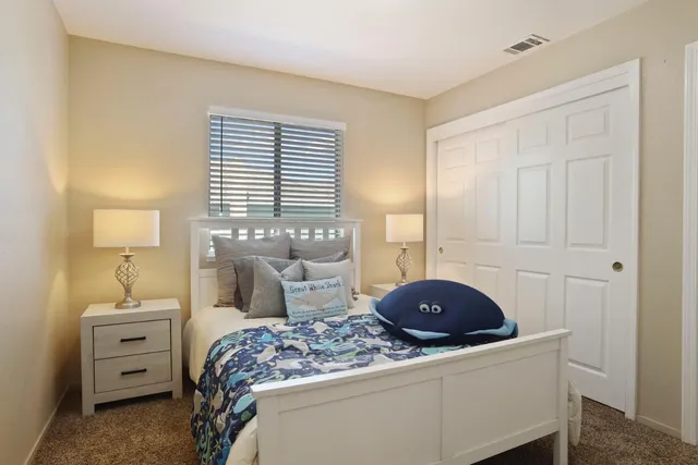 a bedroom with a bed and a chair